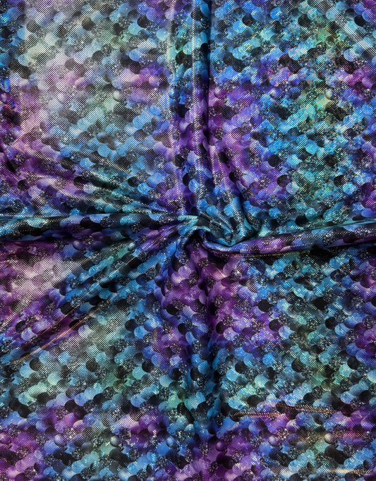 Close-up of tie-dye fabric with purple, blue, and black colors.