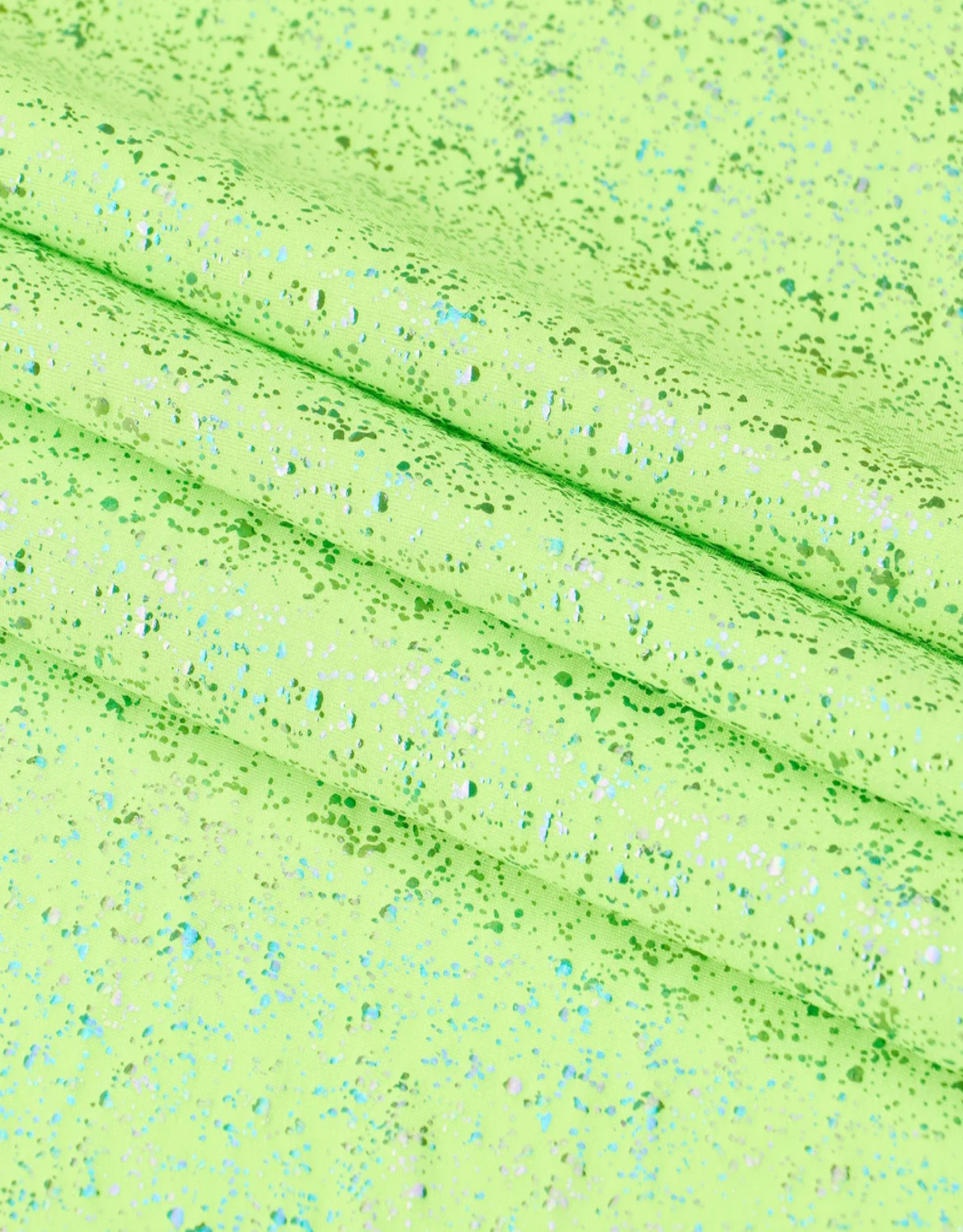 Close-up of a textured green fabric with speckles