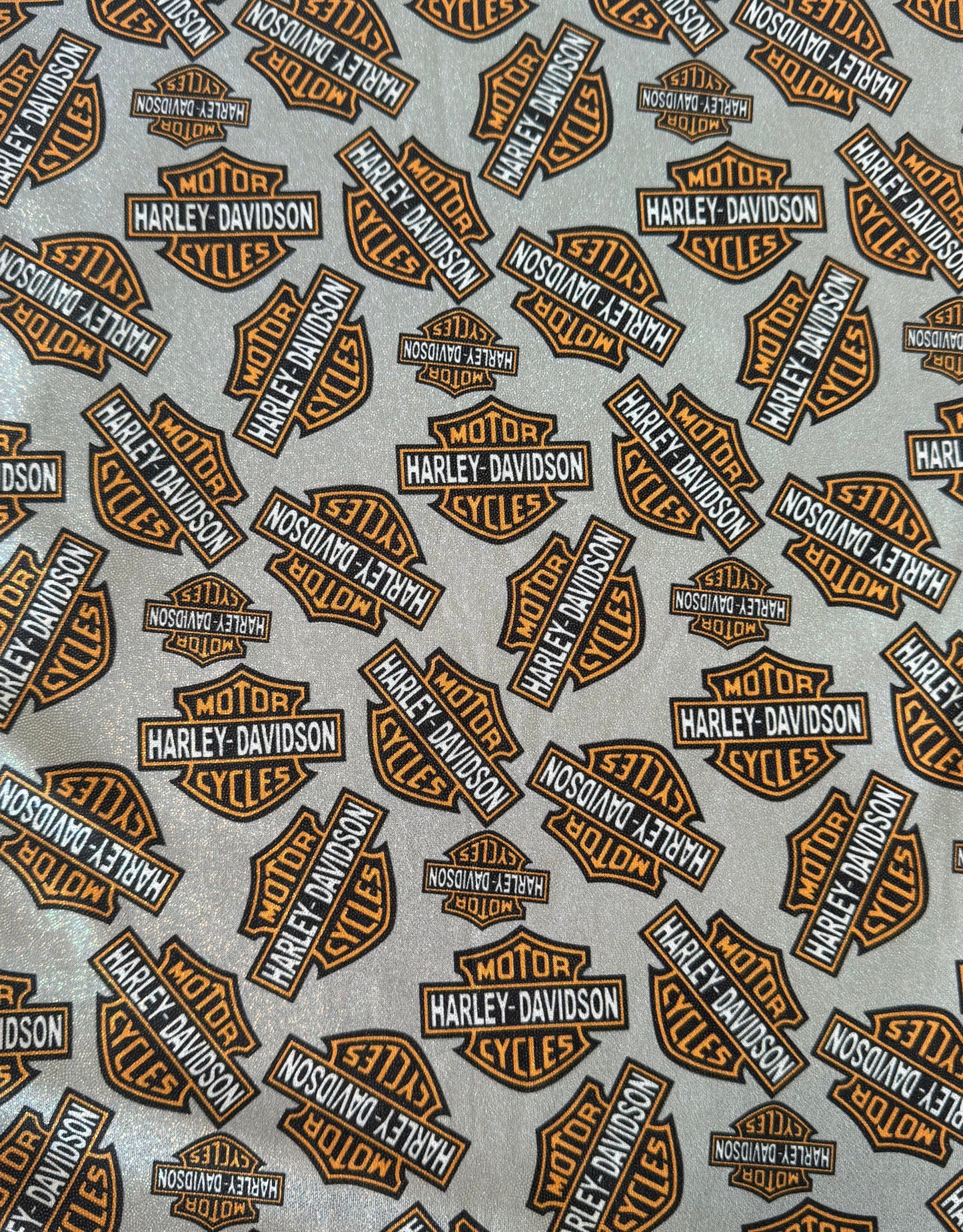 Harley Davidson logos in brown and black on a gray background