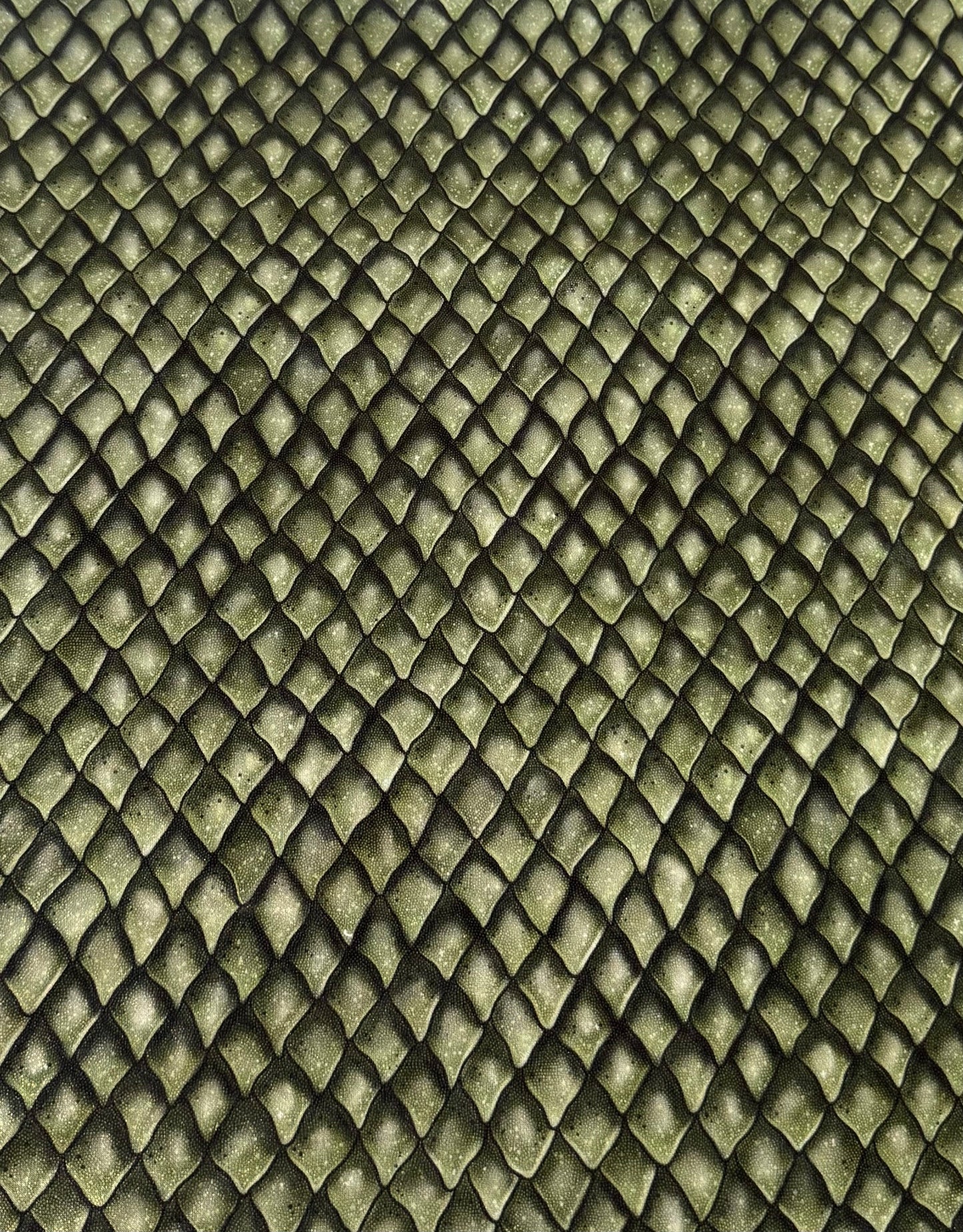 Textured green fabric with a diamond pattern