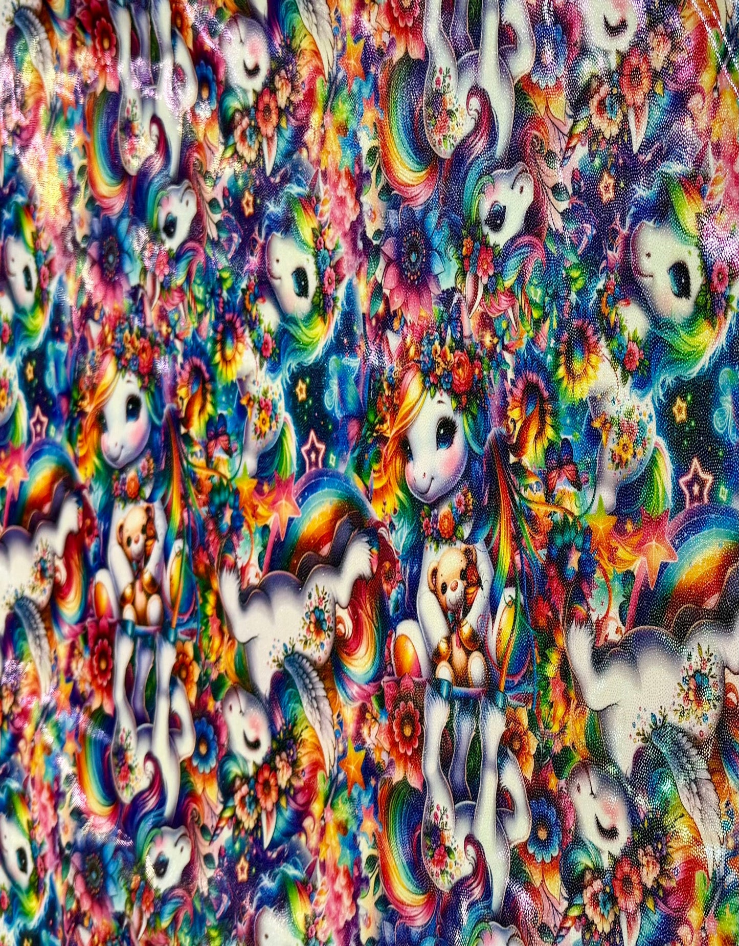 Colorful fabric pattern with unicorns, rainbows, and flowers