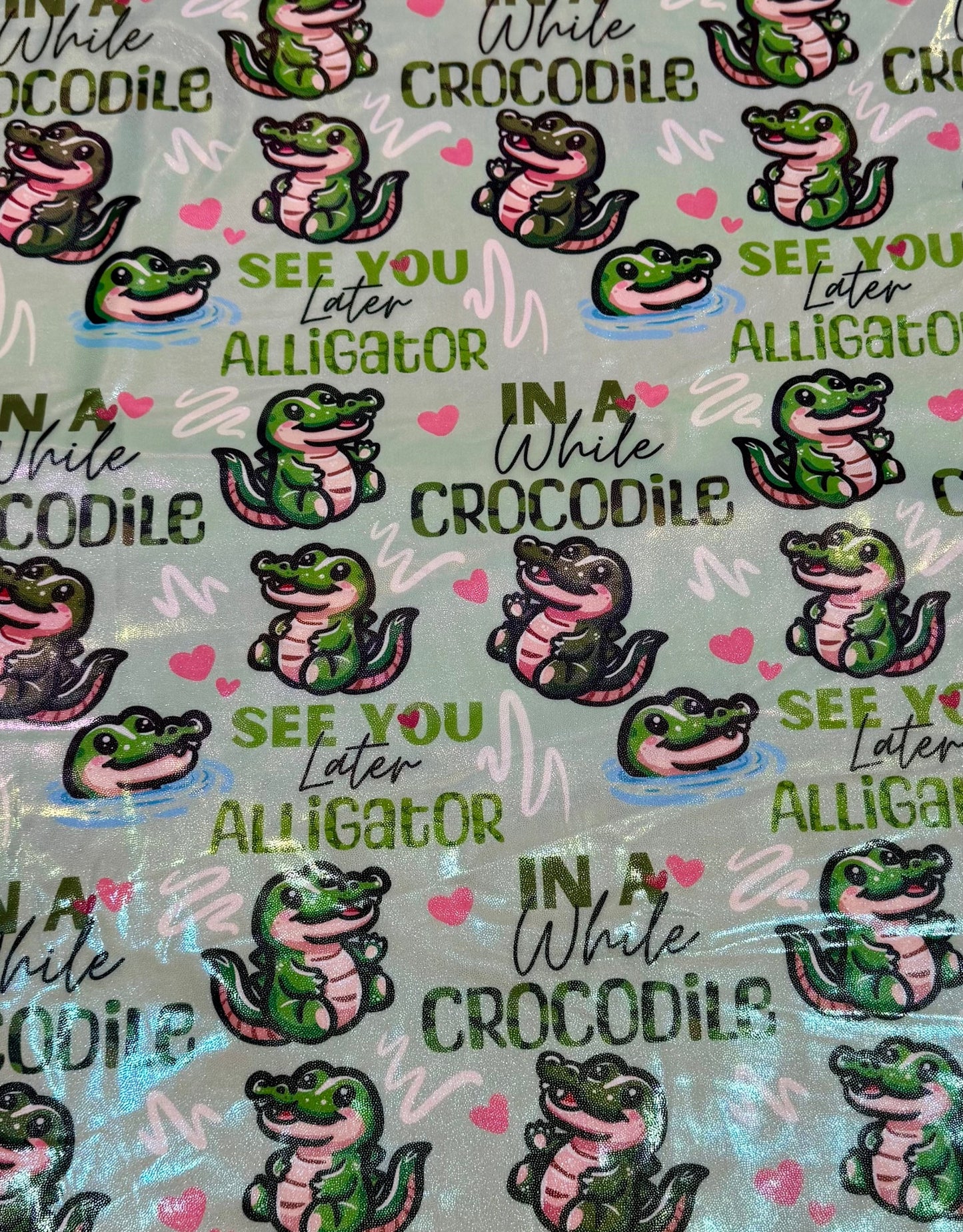 Pattern of alligators and text on a green background