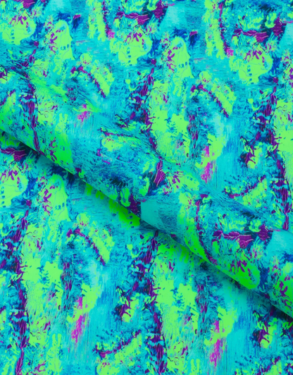 Colorful abstract patterned fabric with green, blue, and purple colors.