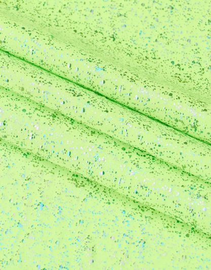 Close-up of a textured green fabric with speckles