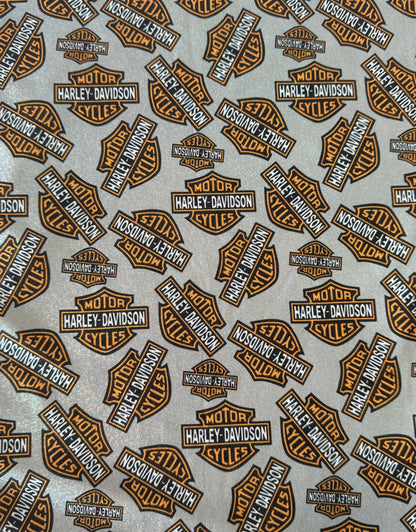 Harley Davidson logos in brown and black on a gray background