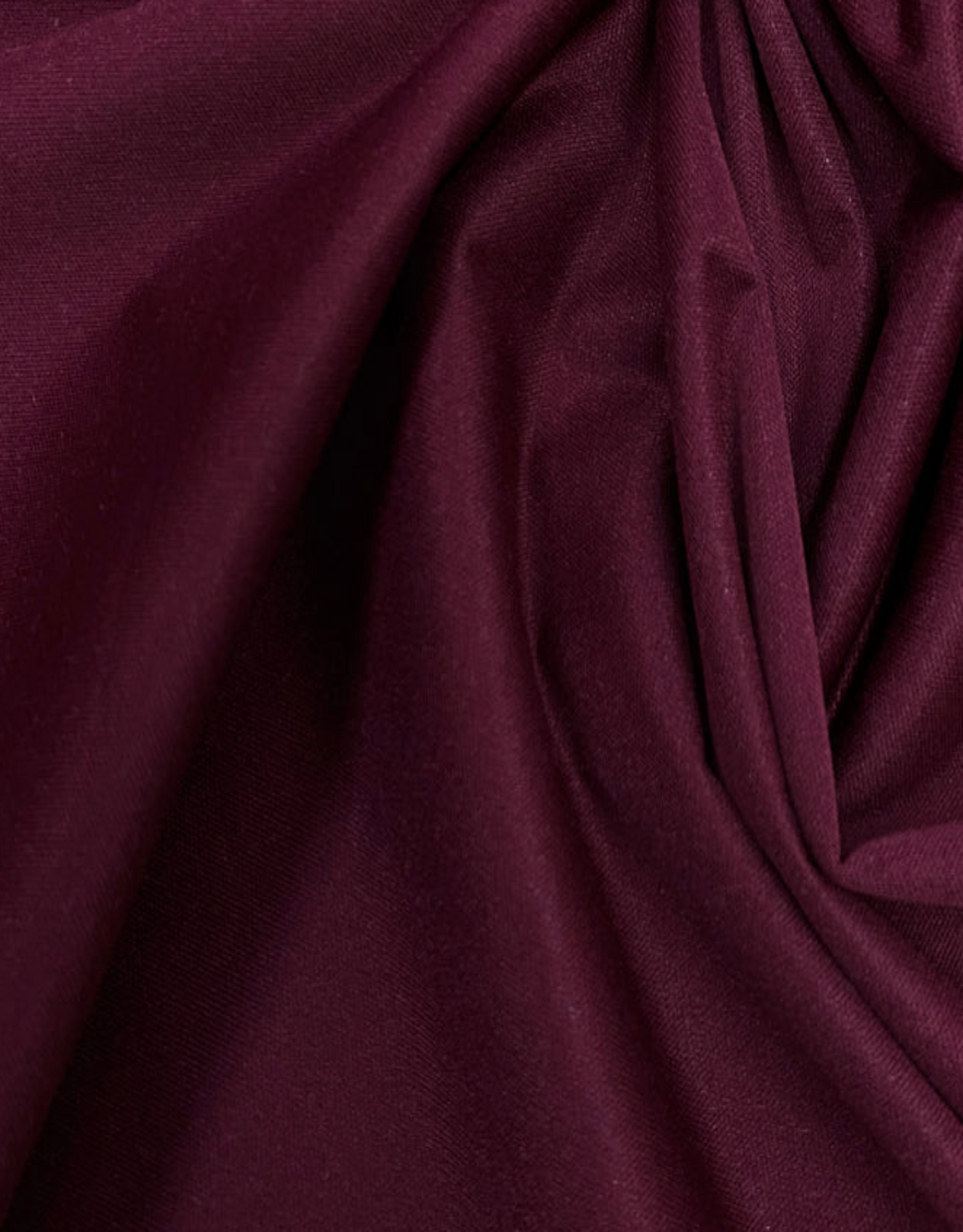 Close-up of dark purple fabric with folds